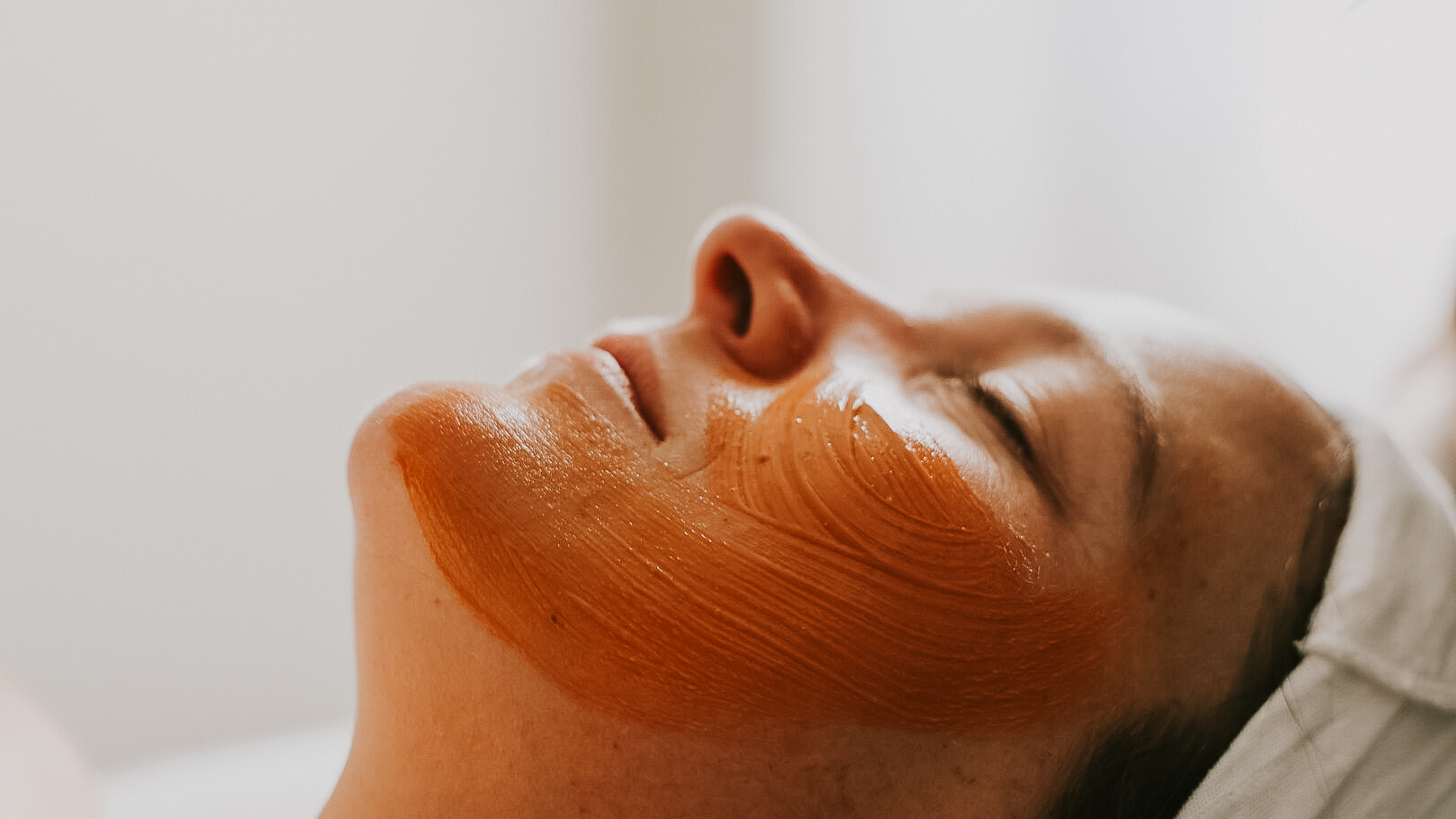 Side profile of a womens face with a hydrating facial mask
