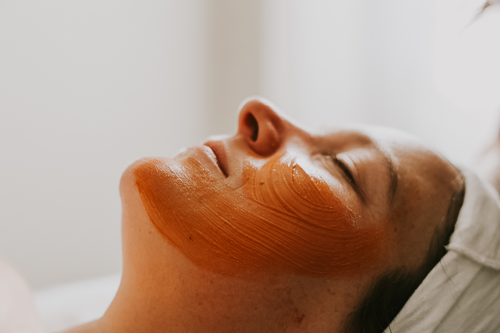 Side profile of a womens face with a hydrating facial mask